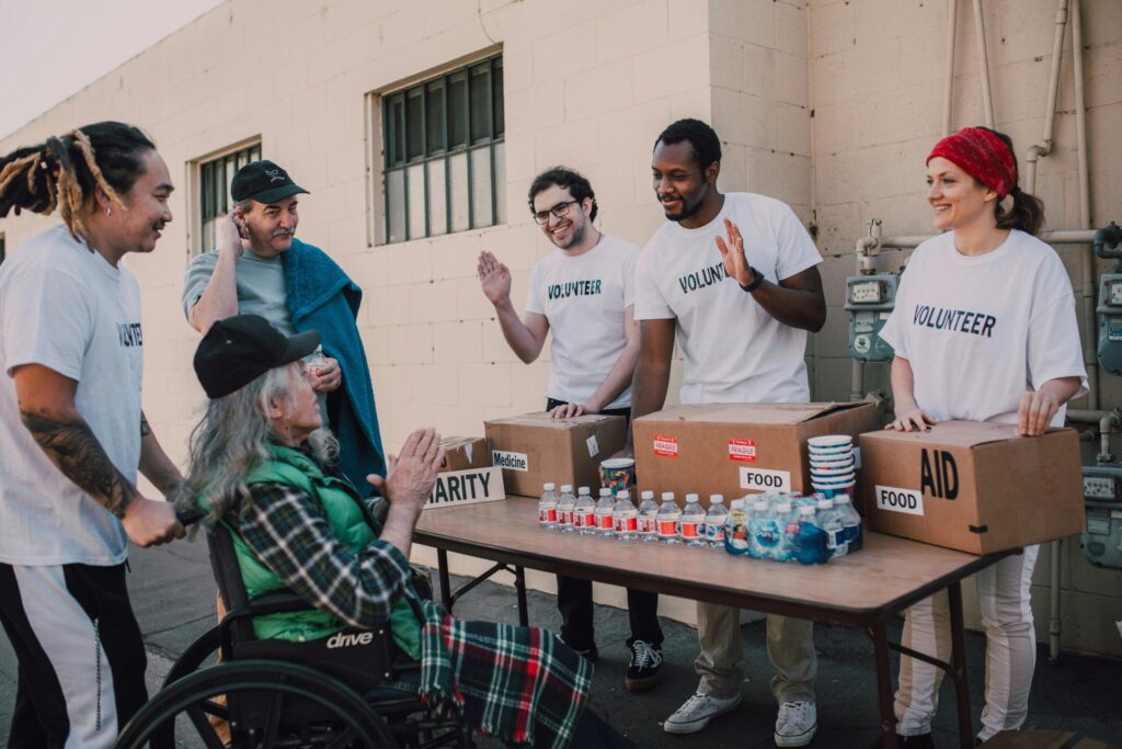 a group of volunteers selling food and aid to guests.